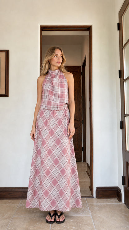 Woman wearing pink plaid halter top and matching maxi skirt