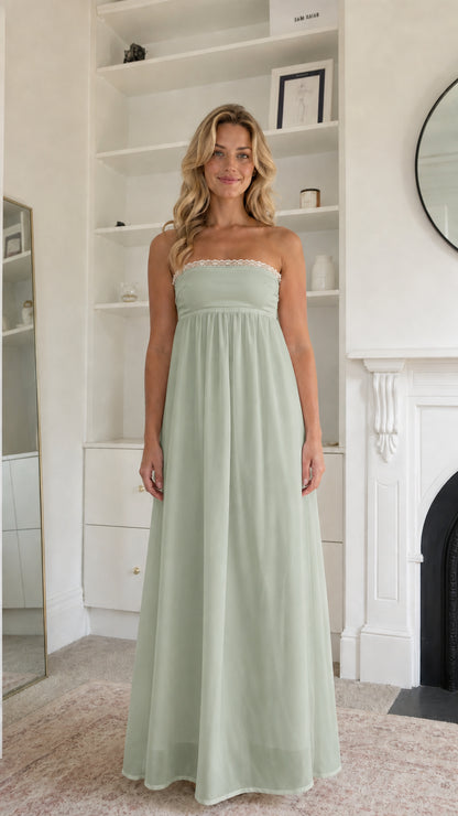 Woman wearing sage green strapless maxi dress