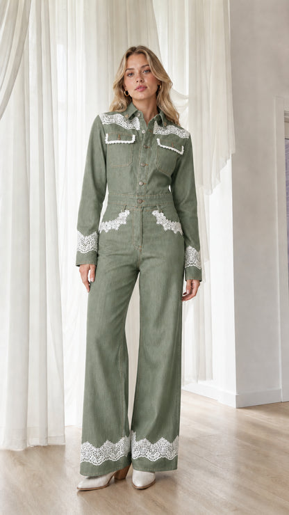 Model wearing sage green western lace trim denim jumpsuit