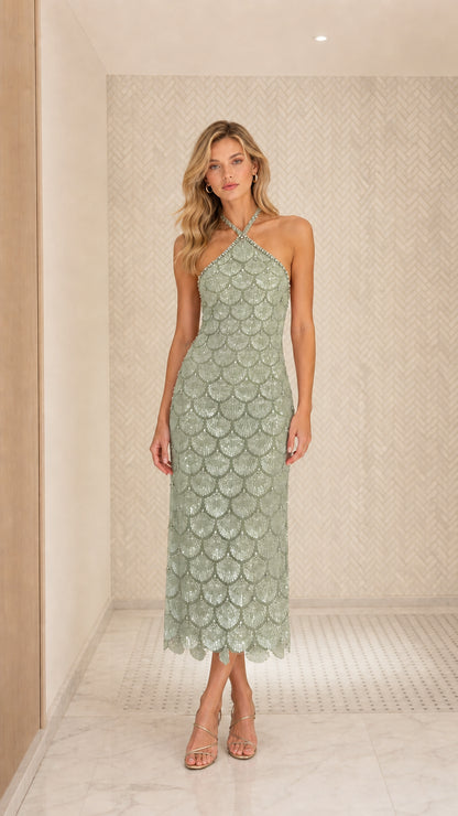 Front view of model wearing sage green sequin halter midi dress