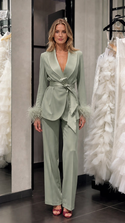 Model wearing sage green satin feather cuff pantsuit set