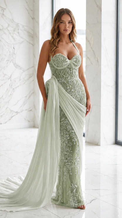 Model wearing sage green beaded evening gown with white draped train