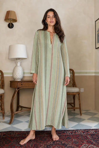 Model wearing sage green vertical stripe long sleeve maxi dress