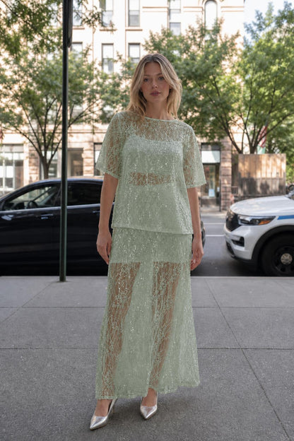 Woman wearing sage green sheer sequin lace two-piece set