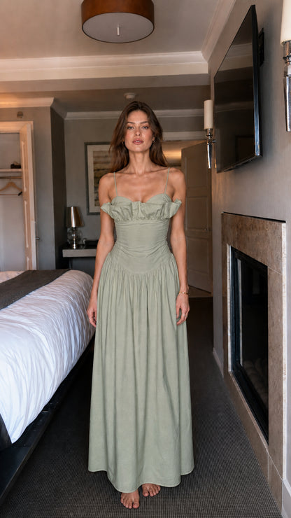 Full view of woman wearing sage green ruffled maxi dress
