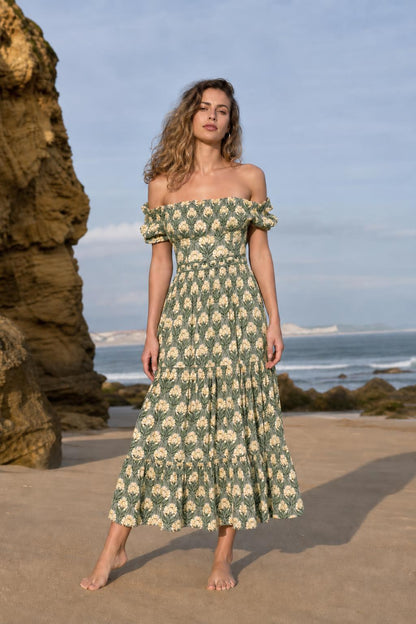 Woman wearing green floral off-the-shoulder midi dress