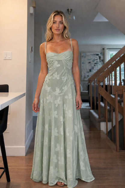 Front view of woman wearing sage green floral jacquard maxi dress