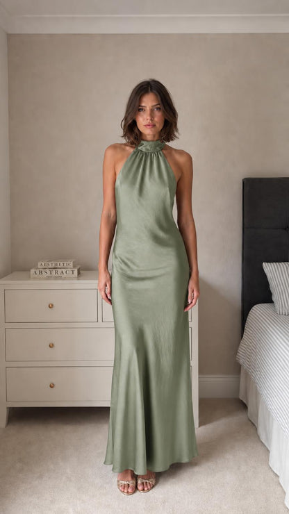Model wearing sage green satin halter neck maxi dress