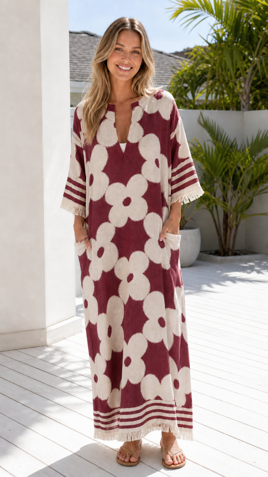 Woman wearing burgundy and white floral jacquard maxi dress