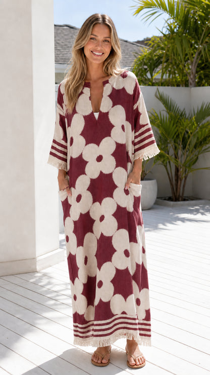 Woman wearing burgundy and white floral jacquard maxi dress