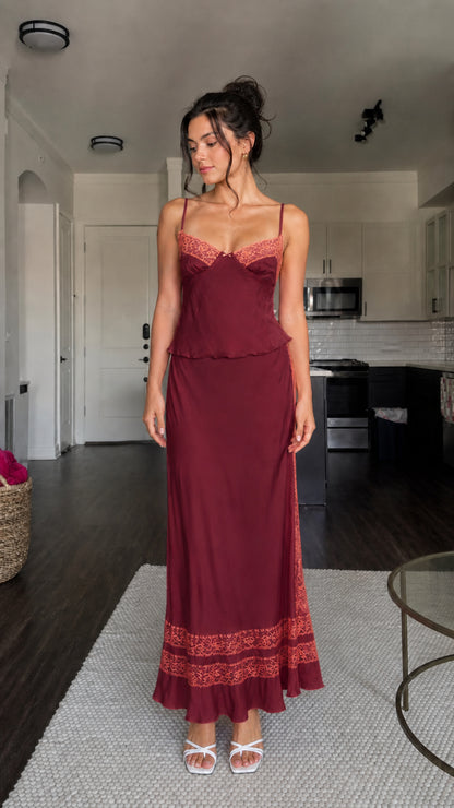 Model wearing burgundy two-piece satin set