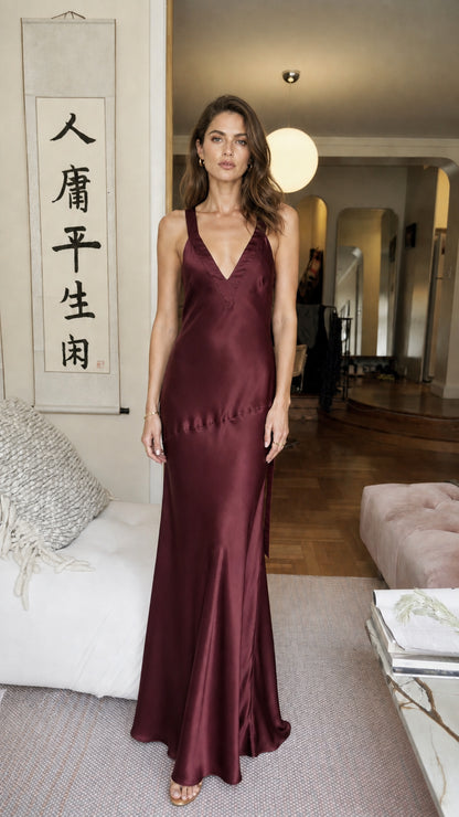 Front view of model wearing burgundy satin V-neck maxi dress