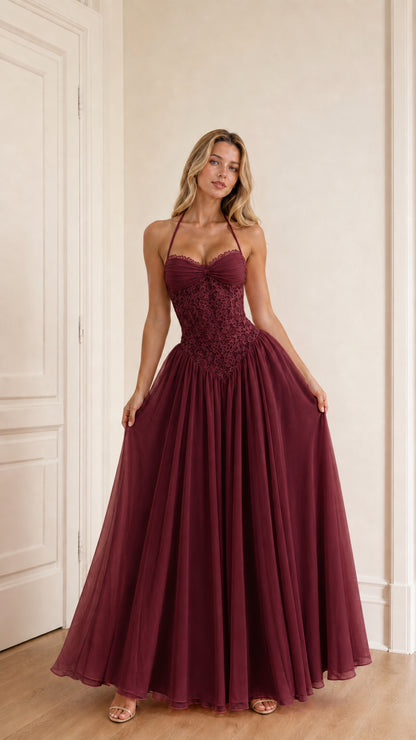 Model wearing burgundy evening dress front view
