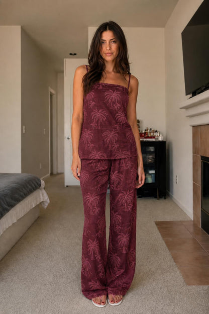 Front view of woman wearing burgundy palm embroidered two-piece set