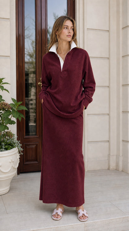 Woman wearing burgundy long-sleeve polo sweatshirt and maxi skirt set
