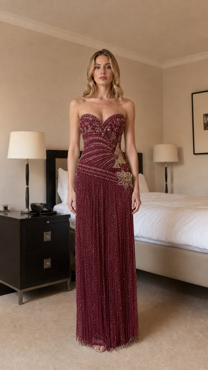 Front view of burgundy beaded strapless evening dress