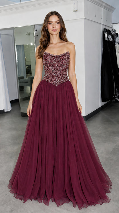 Front view of model wearing burgundy formal gown