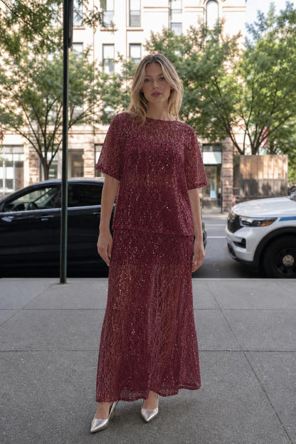 Woman wearing burgundy sheer sequin lace two-piece set