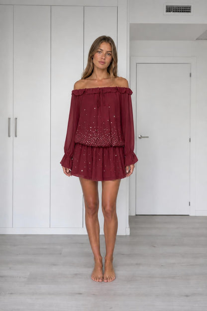 Front view of model wearing burgundy off-the-shoulder chiffon mini dress