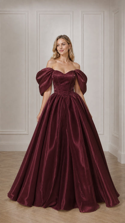 Full view of woman in burgundy off-the-shoulder satin ball gown