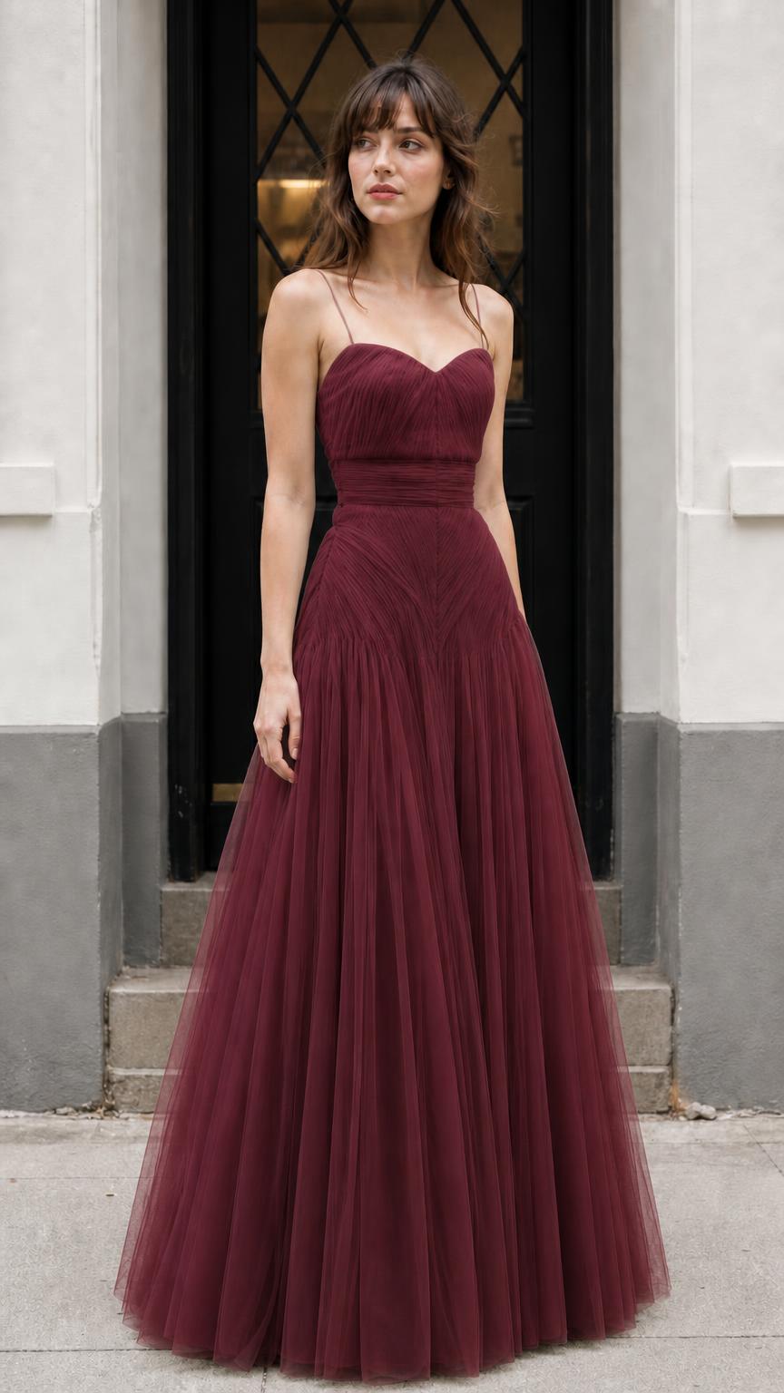 Front view of model wearing burgundy formal tulle gown