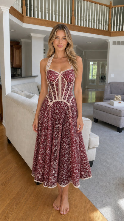 Woman wearing burgundy lace corset midi dress