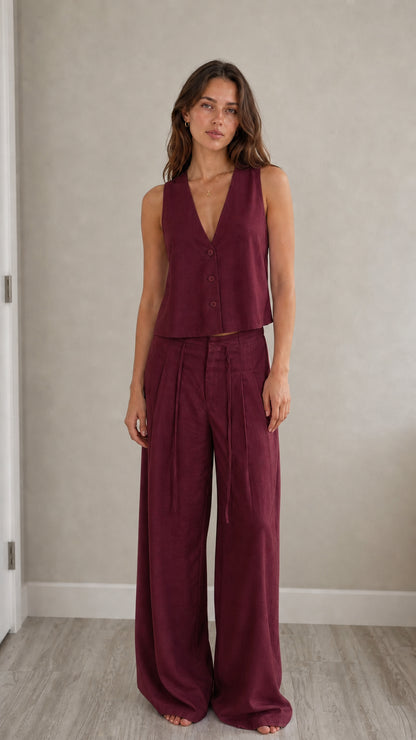 Full-length view of model in burgundy two-piece vest and pants set