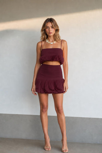 Front view of model wearing burgundy two-piece set