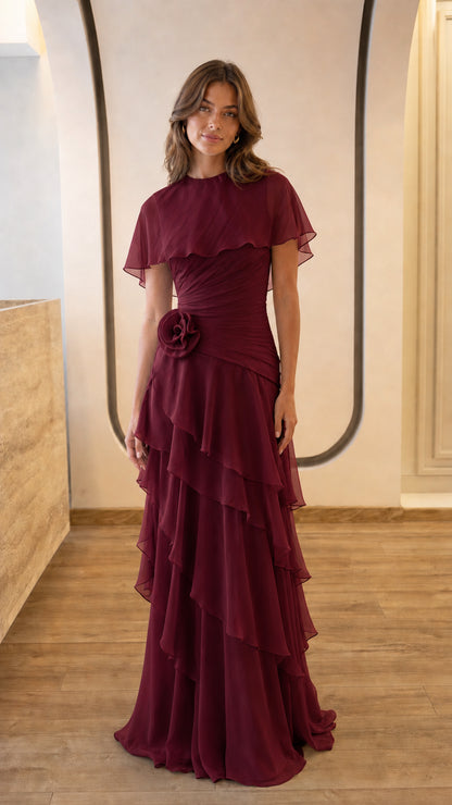 Full view of burgundy evening gown with floral accent