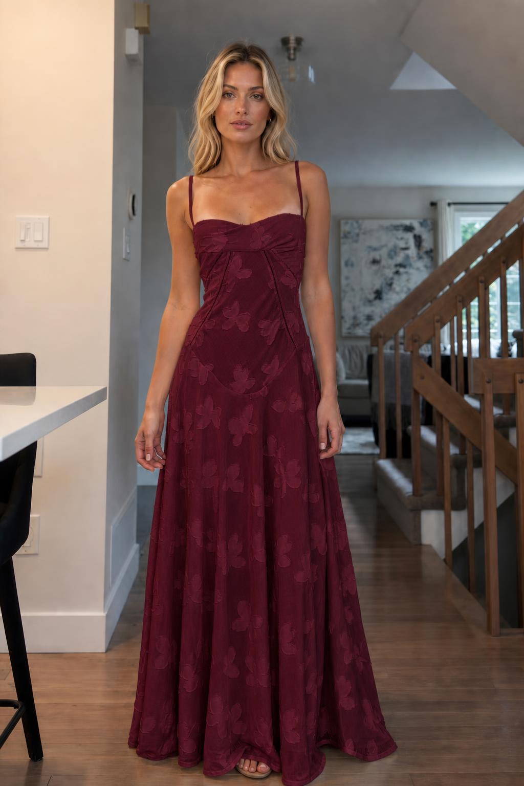 Front view of woman wearing burgundy floral jacquard maxi dress