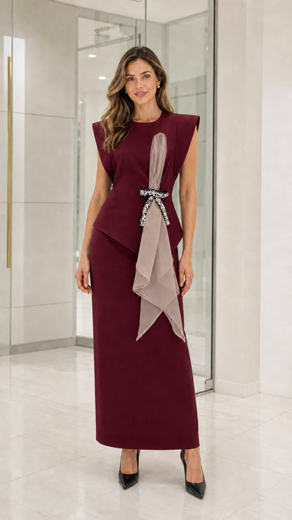 Woman wearing burgundy formal maxi dress with draping sash
