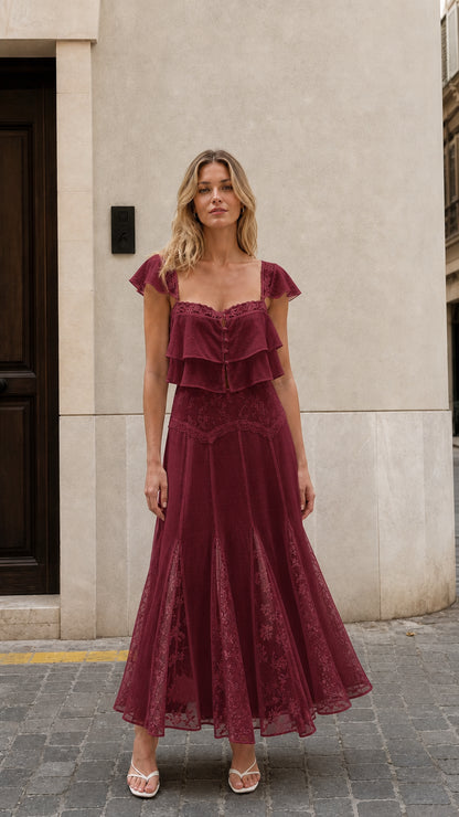 Front view of woman wearing burgundy ruffled two-piece maxi set