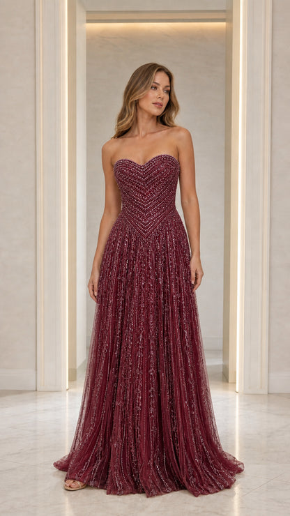 Front view of model in Burgundy strapless beaded gown