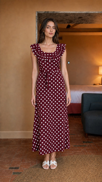 Woman wearing burgundy polka dot midi dress