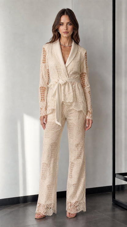 Woman wearing beige lace blazer and trousers set