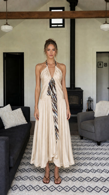 Front view of woman wearing champagne halter neck long dress