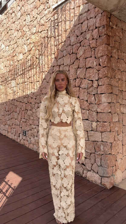 Model wearing cream crochet lace two-piece set