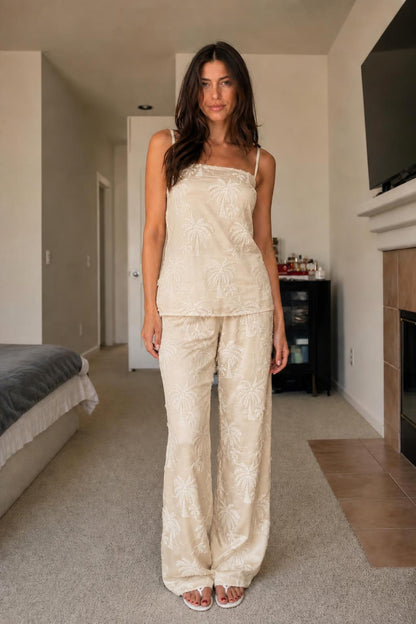 Front view of woman wearing beige palm embroidered two-piece set