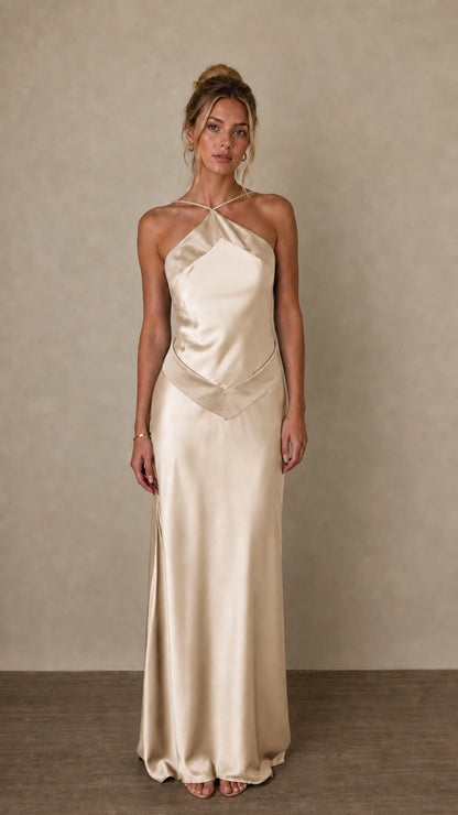 Front view of champagne satin halter maxi dress on model