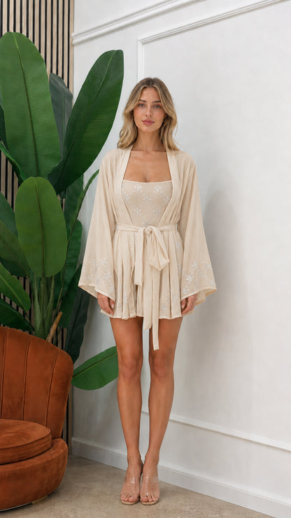Front view of model wearing beige embellished three-piece kimono set