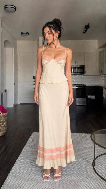 Model wearing champagne two-piece satin set